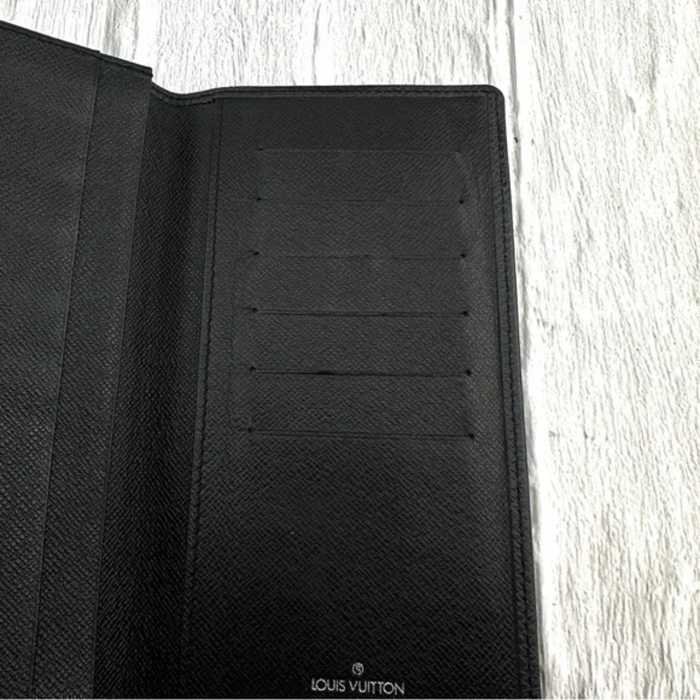 AUTHENTIC Louis Vuitton Taiga wallet. Previously owned. Color: Black.